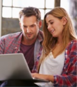 Male and Female Looking at Computer